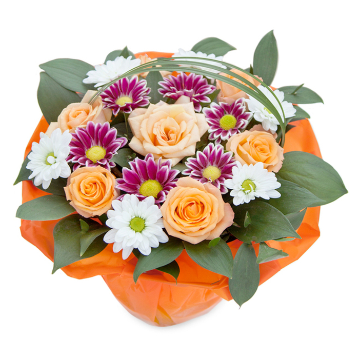Captured against a luminous white background in the gentle light found on a spring morning in Luton, this lush bouquet showcases the artistry of the town's skilled florists. At its core, velvety roses unfurl in shades ranging from soft apricot to brilliant orange, their layered petals glowing with vitality and hope. These centerpieces are interspersed with starburst chrysanthemums, some gleaming pure white with invigorating lime-green centers reminiscent of daisies that grace the paths of Leagrave Park, while others pop with magenta and violet petals for a touch of drama. Layered beneath, rich dark foliage offers contrast and structure, echoing the green landscape surrounding Luton's historic estates. A slender, looping accent of bear grass adds a touch of modern whimsy, drawing the eye and uniting the design. Bound at the base with crinkled, vibrant orange cellophane, the bouquet radiates enthusiasm and care-perfect for gifting at birthdays, congratulating a milestone, or simply sharing the beauty of fresh flowers. Infused with a sense of community and heartfelt craftsmanship, this arrangement is ready to deliver light and celebration all across Luton.