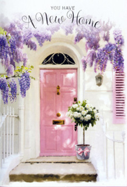 Imagine walking through a peaceful corner of Luton, perhaps past the characterful homes near Stockwood Park, and pausing at a doorway that seems to glow with quiet joy. At its centre is a pale pink front door, painted in a soft, chalky shade that radiates warmth and a sense of gentle welcome. The door is framed by cascading wisteria, its blossoms hanging in generous trails from above, forming loose, fragrant curtains of lavender and lilac. Each tiny flower contributes to a mist of colour, shifting between sunlit and shadowed tones as the light glides across the façade. The surrounding wall is whitewashed and slightly textured, and a softly painted shutter on one side reflects the pink hues of the door, tying the elements into a balanced, pastel composition. Anchored at the threshold, a weathered grey bucket sits firmly on the step, serving as a simple yet charming vessel for a lush floral arrangement. Inside, creamy white roses are nestled tightly together, their velvety petals layered in full spirals that suggest softness and abundance. Sprigs of soft green foliage peek between the blooms, offering contrast and a hint of garden freshness, like greenery picked from a planted border along the edges of a Luton garden. Wrapped around the bucket, a delicate pink ribbon is tied into an elegant bow, providing a final note of romance and care. The atmosphere is soothing yet quietly celebratory-an image that beautifully captures what a thoughtful housewarming bouquet might look like when delivered to a new home in Luton, bringing with it comfort, heartfelt congratulations, and a reassuring sense that this threshold is ready to become truly lived-in.